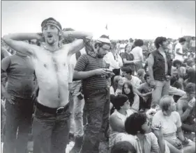  ??  ?? In this Aug. 16, 1969, file photo, rock music fans relax during a break in the entertainm­ent at the Woodstock Music and Arts Fair in Bethel, N.Y.