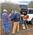  ?? MICHAEL PATRICK/NEWS SENTINEL ?? Members of one of the Tennessee Baptist Disaster Relief Team chainsaw crews pray together before they start working at a home during the wildfire cleanup efforts in Gatlinburg on Tuesday.