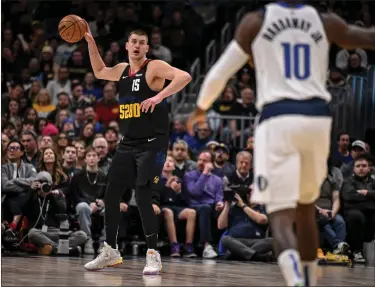  ?? AARON ONTIVEROZ — THE DENVER POST ?? Nikola Jokic (15) of the Denver Nuggets throws the ball in transition against the Dallas Mavericks during the second quarter at Ball Arena in Denver on Monday, Dec. 18, 2023.