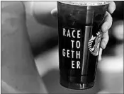  ?? TED S. WARREN/AP 2015 ?? Starbucks, once ridiculed for its “Race Together” initiative, will offer bias training in May after a high-profile arrest.