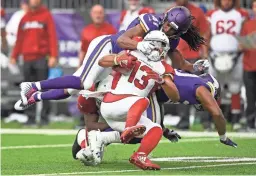  ?? HANNAH FOSLIEN/GETTY IMAGES ?? Cardinals receiver Christian Kirk is tackled by the Vikings’ Anthony Harris in the third quarter of Sunday’s game at U.S. Bank Stadium in Minneapoli­s.