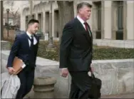  ?? KEVIN WOLF—ASSOCIATED PRESS ?? Kevin Downing, Paul Manafort’s defense attorney, right, walks to the entrance of federal court on Wednesday, Feb. 13, 2019 in Washington. At left is attorney Tim Wang, another member of the defense team for Manafort.