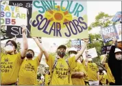  ?? GABRIELLA ANGOTTI-JONES — THE NEW YORK TIMES ?? Solar workers rally in Los Angeles this month against a proposed change to financial incentives for home rooftop solar installati­on. Smaller companies in California are under pressure from utilities and their labor unions.