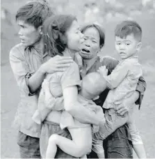  ?? HORST FAAS/THE ASSOCIATED PRESS/PBS ?? Civilians huddle together after an attack by South Vietnamese forces in Dong Xoai in June 1965. Given that the Vietnam conflict was the first television war, it is fitting that the definitive statement should be made in that medium, Jack Todd writes.