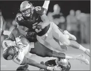  ?? Arkansas Democrat-Gazette/THOMAS METTHE ?? Harding linebacker Chris Wein (25) tackles Ouachita Baptist wide receiver La’Darius McElroy (8) during the third quarter of the Bisons’ loss to the Tigers on Saturday in Searcy.