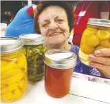  ?? NICK BRANCACCIO ?? Julie Dunkley displays a variety of homegrown produce last August for the 2019 Harrow Fair. This year’s 166th edition of the fair has been postponed until 2021.