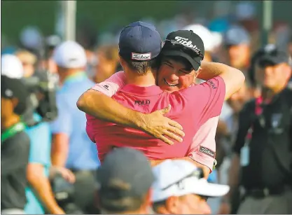  ?? WARREN LITTLE — GETTY IMAGES ?? Justin Thomas hugs his father, Mike, a PGA pro, after earning his first major victory Sunday in the PGA Championsh­ip.