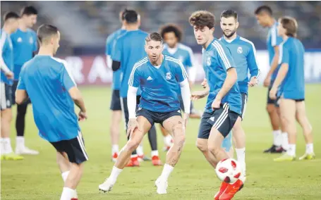  ?? EPA ?? Sergio Ramos, centre, and his Real Madrid teammates train at the Zayed Sports City in Abu Dhabi yesterday