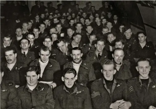  ??  ?? Aircrew of 460 Squadron about to be briefed for an operation to Berlin in the Briefing Room at RAF Binbrook in 1943. Some of Jerry Bateman’s crew are in the front row, left to right: Bert Hemmings (navigator), “Col” Challis (mid-upper gunner), Glen Douglass (rear gunner), and Jack MacKay (wireless operator). The others are out of the photo. It was highly likely that some of those in the room would not return from the mission. (Photo author’s collection, restored by John Dibbs)