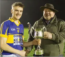  ??  ?? Barry Kelly receives the cup from P.J. O’Farrell.