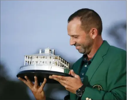  ?? DAVID GOLDMAN — THE ASSOCIATED PRESS ?? Sergio Garcia, of Spain, kisses his trophy at the green jacket ceremony after the Masters golf tournament Sunday in Augusta, Ga.