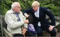  ?? AP/STEFAN ROUSSEAU ?? Boris Johnson (right), a candidate to lead Britain’s governing Conservati­ve Party, talks to a visitor Tuesday as he tours the Royal Horticultu­ral Society garden at Wisley, England.