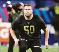  ?? Darron Cummings / Associated Press ?? Michigan offensive lineman Andrew Stueber runs a drill during the NFL scouting combine on March 4 in Indianapol­is.
