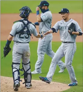  ?? The Associated Press ?? Seattle Mariners relief pitcher Yoshihisa Hirano, right, celebrates with catcher Austin Nola, left, and first baseman Jose Marmolejos after they defeated the San Diego Padres in a doublehead­er nightcap on Thursday.