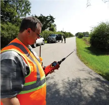  ?? (Photo by Gregory Bull, AP) ?? Mike Cossey, of Bureau Veritas, uses an air monitor to check the quality of air at a police roadblock marking the 1.5-mile perimeter of the evacuation area around the Arkema Inc. chemical plant Thursday, Aug. 31, 2017, in Crosby, Texas. The...