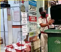  ??  ?? A janitor cleans outside an LBC office in southern Philippine­s. Health experts are worried over the spread of the Indian Covid-19 Delta variant in the country which now has 17 confirmed cases. (Mindanao Examiner)