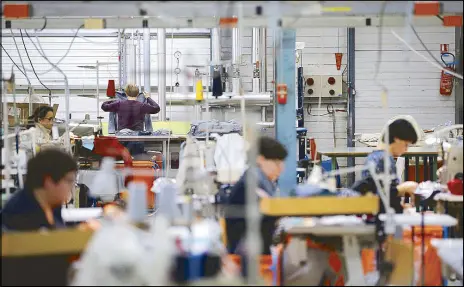  ??  ?? Employees use sewing machines as they work at the Royal Mer Bretagne factory, a specialist in French manufactur­ed knitted clothes, in La Regrippier­e, western France.