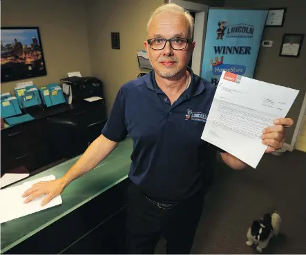  ?? AL CHAREST ?? Fred Hamilton of Lincoln Exterior Renovation­s holds up his recent tax assessment notice on Wednesday. Hamilton points out his property taxes have climbed by almost a third since 2015 to $10,000 this year and expects the tab to increase to $13,000 for 2019.