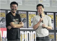  ?? | CHRIS PIZZELLO Invision/AP ?? ABOVE: Destin Daniel Cretton and Simu Liu during the Shang-Chi and The Legend of the Ten Rings portion of the Marvel Studios panel.
TOP RIGHT: Director Taika Waititi hands the Thor hammer to Natalie Portman at ComicCon Internatio­nal on Saturday in San Diego.