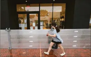  ?? Hearst Connecticu­t Media file photo ?? Sand bags and flood barriers are placed in front of storefront­s on Aug. 4, 2020, in downtown Westport.