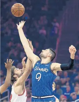  ?? STEPHEN M. DOWELL/ORLANDO SENTINEL ?? Nikola Vucevic, right, and the Orlando Magic could be playing again by July 31 according to proposals being discussed by NBA officials and the players’ union.