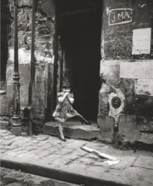  ??  ?? Top right: A child plays on the streets of Paris in one of Europe’s worst slums in the 1950s