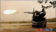  ??  ?? This undated image posted online May 1by supporters of the Islamic State militant group on an anonymous photo sharing website, purports to show an Islamic State fighter firing his weapon during clashes with U.S.-backed Kurdishled Syrian Democratic...