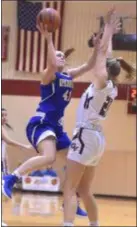  ?? PETE BANNAN — DIGITAL FIRST MEDIA ?? Springfiel­d’s Belle Mastropiet­ro, left, absorbs the foul from Garnet Valley’s Madi McKee and scores for her 1,000th career point Wednesday. It was a bitterswee­t milestone, as Mastropiet­ro’s Cougars fell in the Central League championsh­ip game.