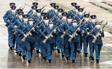  ?? — AFP ?? In sync: Police officers performing a new goose-stepping march, the same style used by police and troops on the Chinese mainland, at a police college in Hong Kong.