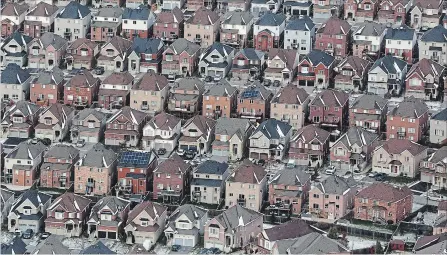  ?? LARS HAGBERG THE CANADIAN PRESS ?? Aerial view of houses in Oshawa. The Caanadian Real Estate Associatio­n says last month was the weakest January for residentia­l sales since 2015, with the number of transactio­ns down four per cent nationally from last year.