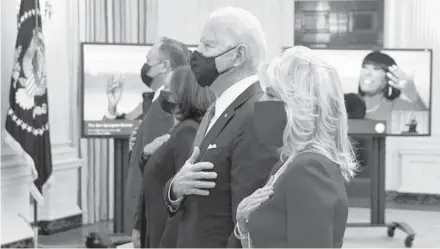  ?? ALEX WONG/GETTY ?? First lady Jill Biden, right, President Joe Biden, Vice President Kamala Harris and second gentleman Doug Emhoff listen to the national anthem Thursday as they watch the virtual presidenti­al inaugural prayer service at the White House.