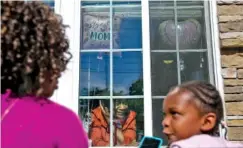  ?? AP PHOTO/BRYNN ANDERSON ?? Mary Washington, 73, speaks through a window Sunday to her daughter, Courtney Crosby, and grandchild, Sydney Crosby, for a Mother's Day celebratio­n at Provident Village at Creekside in Smyrna, Ga.