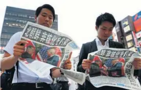  ?? AP ?? Japoneses se informaban de la cumbre entre Trump y Kim en el diario Mainichi Shimbun, de Tokio, que imprimió una edición extra ayer.