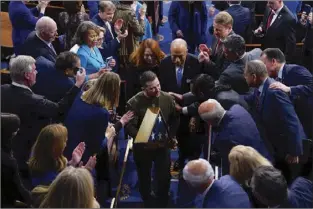  ?? AP photo ?? Ukrainian President Volodymyr Zelenskyy holds an American flag that was gifted to him by House Speaker Nancy Pelosi of Calif., as he leaves after addressing a joint meeting of Congress on Capitol Hill in Washington on Wednesday.