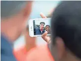  ??  ?? A fan takes a selfie with celebrity scientist Bill Nye in Washington, D.C.