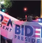  ?? ANDREW HARNIK/AP ?? Supporters of Democratic presidenti­al nominee Joe Biden hold banners near the White House on Thursday night.