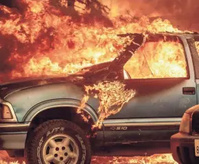  ?? NOAH BERGER/AP ?? Fire consumes a pickup truck on Highway 89 south of Greenville, Calif., in Plumas County on Thursday.