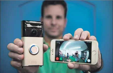  ?? Michael Owen Baker For The Times ?? RING chief Jamie Siminoff, a “Shark Tank” reject, holds one of the camera-equipped doorbells. Amazon paid a reported $1 billion for Ring.