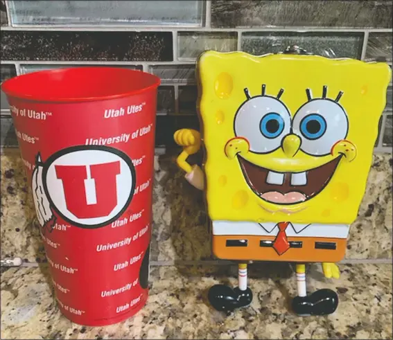  ?? (AP/Andy Larsen) ?? Andy Larsen’s childhood piggybank (right) and a plastic cup are shown. Larsen’s spontaneou­s tweet looking for someone in need to whom he could give the $185 he had in the two items quickly snowballed into tens of thousands of dollars in donations from strangers, as well as messages from people who could use the help.