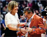  ?? AP PHOTO BY JESSICA HILL ?? Connecticu­t associate head coach Chris Dailey, left, and head coach Geno Auriemma celebrate Auriemma’s 1000th win at the end of an NCAA college basketball game against Oklahoma, Tuesday in Uncasville, Conn.