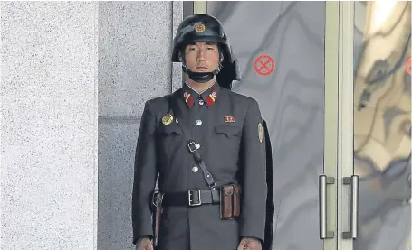  ?? Picture: Getty. ?? A North Korean soldier looks at South Korea across the Korean Demilitari­sed Zone yesterday.