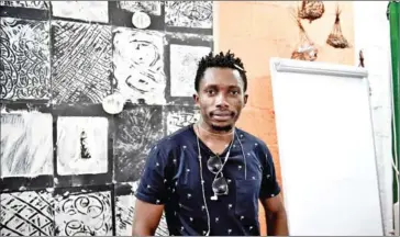  ?? AFP ?? Congolese artist and refugee Richard Lusakumunu at a studio in the refugee camp of Diavata in Greece.