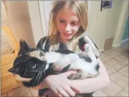  ?? AUDRA HAMMER ROSS – FOR MEDIANEWS GROUP ?? Fiona Ross, 9, holds the family cat Butterscra­tch at home.