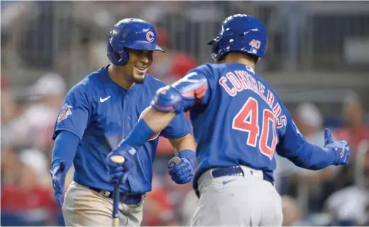  ?? AP ?? The Cubs’ Rafael Ortega is congratula­ted by teammate Willson Contreras after hitting a two-run home run in the fourth inning Saturday against the Nationals.