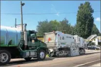  ??  ?? Crews work on recycling and resurfacin­g a stretch along Route 5as part of a larger series of statewide road repair and paving project.