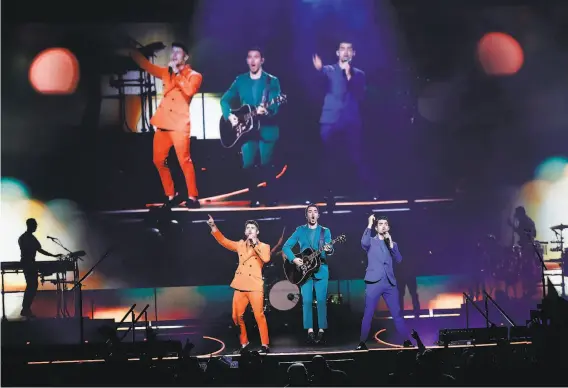  ?? Scott Strazzante / The Chronicle ?? Nick (left), Kevin and Joe Jonas perform Tuesday, Oct. 8, at the Chase Center as part of their reunion tour. The group played old favorites alongside songs from this year’s “Happiness Begins” album.