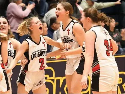  ?? MATTHEW B. MOWERY PHOTOS — MEDIANEWS GROUP ?? From left, Rochester Hills Lutheran Northwest’s Paige Macavage, Aliyah Ozias, Abby Larsen and Ashley Cadicamo celebrate after beating Sandusky in a Division 3quarterfi­nal at SC4Fieldho­use in Port Huron Tuesday, earning the Crusaders’ first-ever trip to the state semifinals.