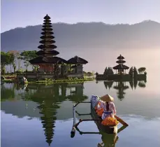  ??  ?? Captivatin­g
contrasts: The high-rise hub of activity that is Hong Kong, left, and the tranquil waters around a temple in central Bali, above