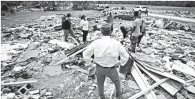  ?? ROBERT WILLETT/THE NEWS & OBSERVER ?? North Carolina Gov. Roy Cooper talks with residents Wednesday after a tornado spawned by Hurricane Isaias hit a rural mobile home neighborho­od near Windsor, N.C.