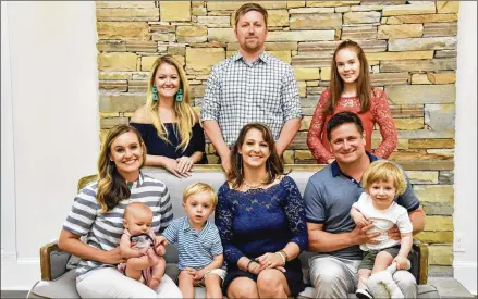  ?? HYOSUB SHIN / HSHIN@AJC.COM ?? Gregg Ivey’s family members pose for a portrait. In front (from left) are Brooke Levenson (sister) — with sons Cameron, 4 months, and Christian, 3 — Julie Ivey (sister), Joe Ivey (brother) and his son, Everett, 2. In back (from left) are Jennifer Ivey, Smith Levenson and Samantha Ivey, 16. Gregg’s siblings say their brother was a sweet, kind soul who loved fishing and kayaking with his beloved dog, River.